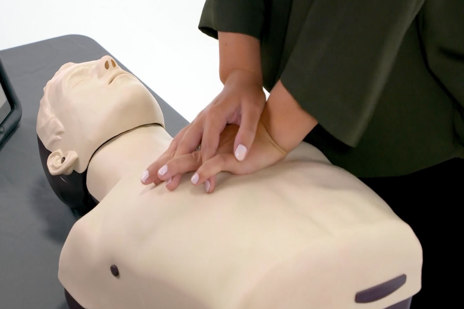 Person practicing resuscitation using a mankikin.